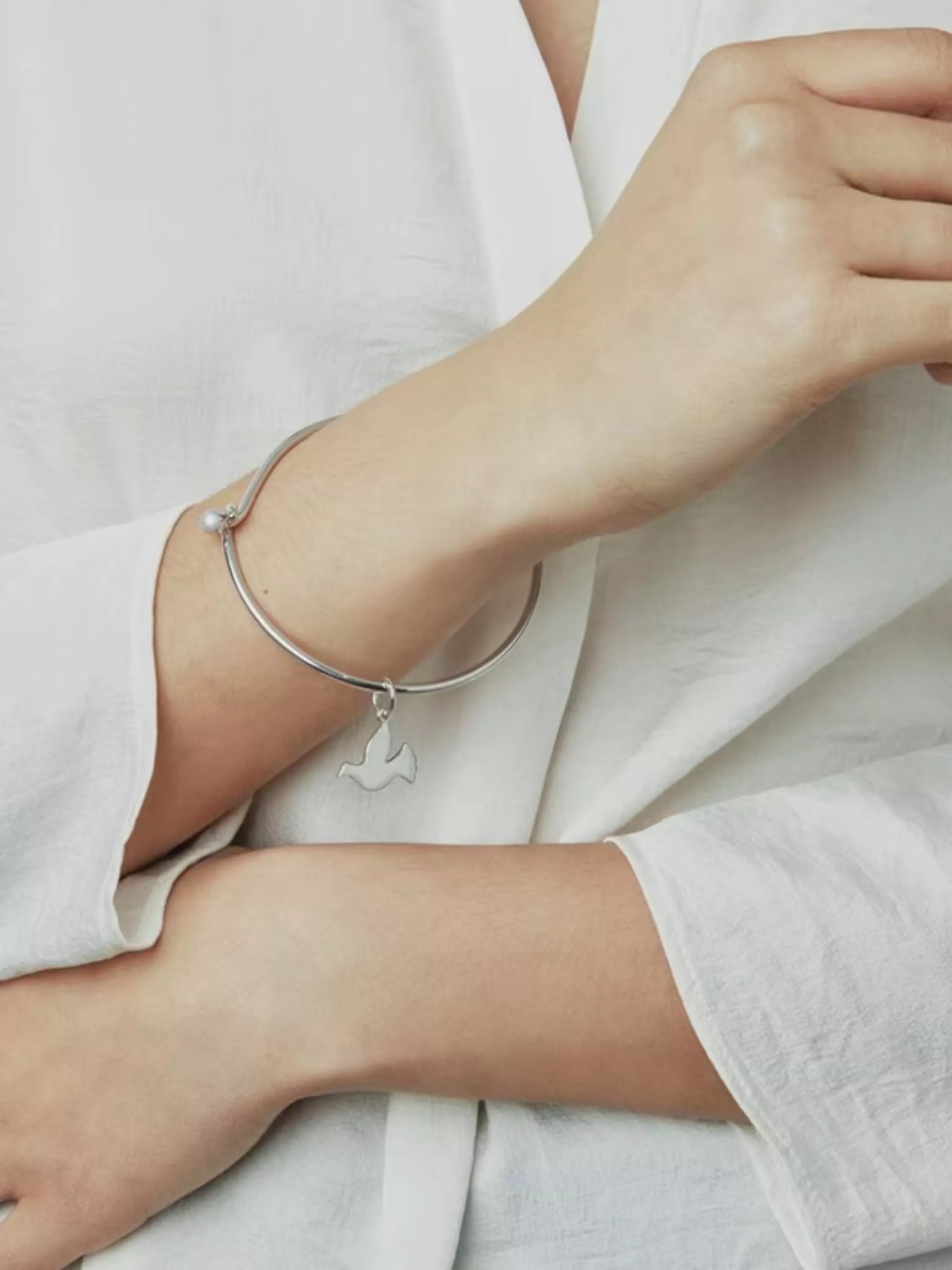 Recognised sterling silver dove bangle, imported from the UK