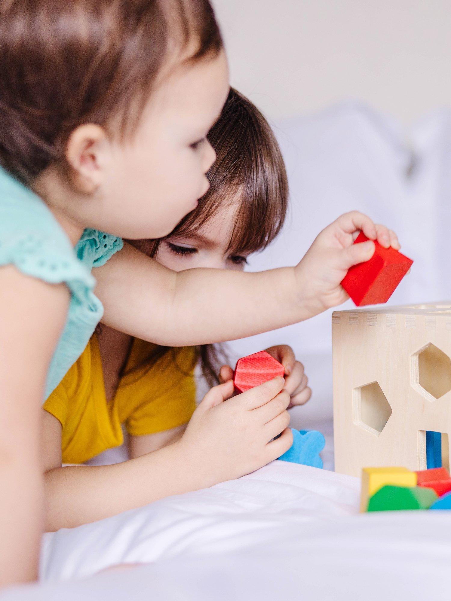 Melissa & Doug wooden shape sorting cube with 12 chunky shapes, imported from the UK