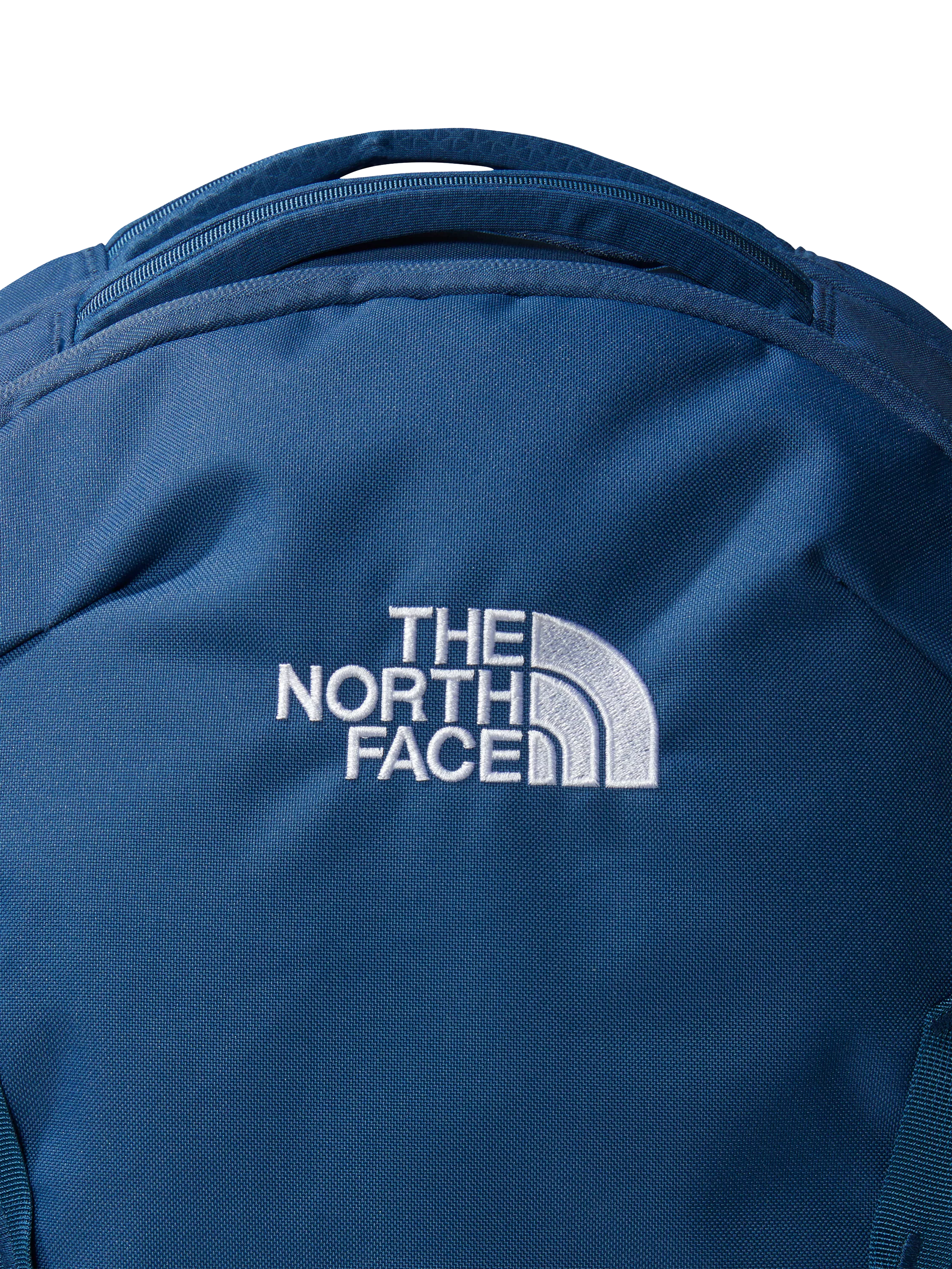 The North Face Vault backpack in blue and white, imported from the UK