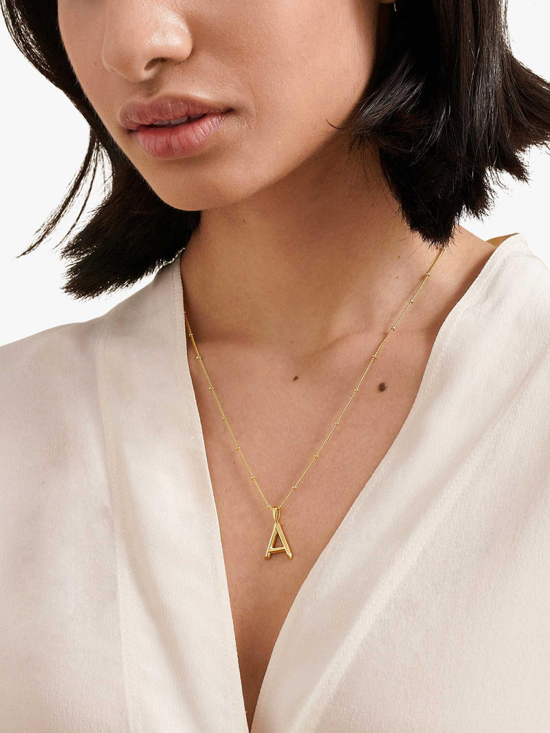 Edge of Ember gold initial pendant necklace (British brand)