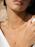 Ottoman Hands gold heart pendant with blue cubic zirconia, UK version