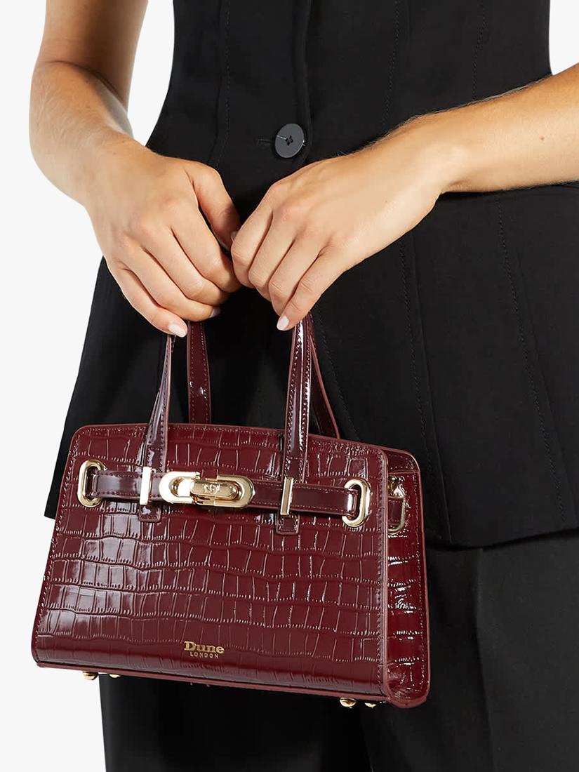 Dune London burgundy leather grab bag with belted detail, imported from the UK