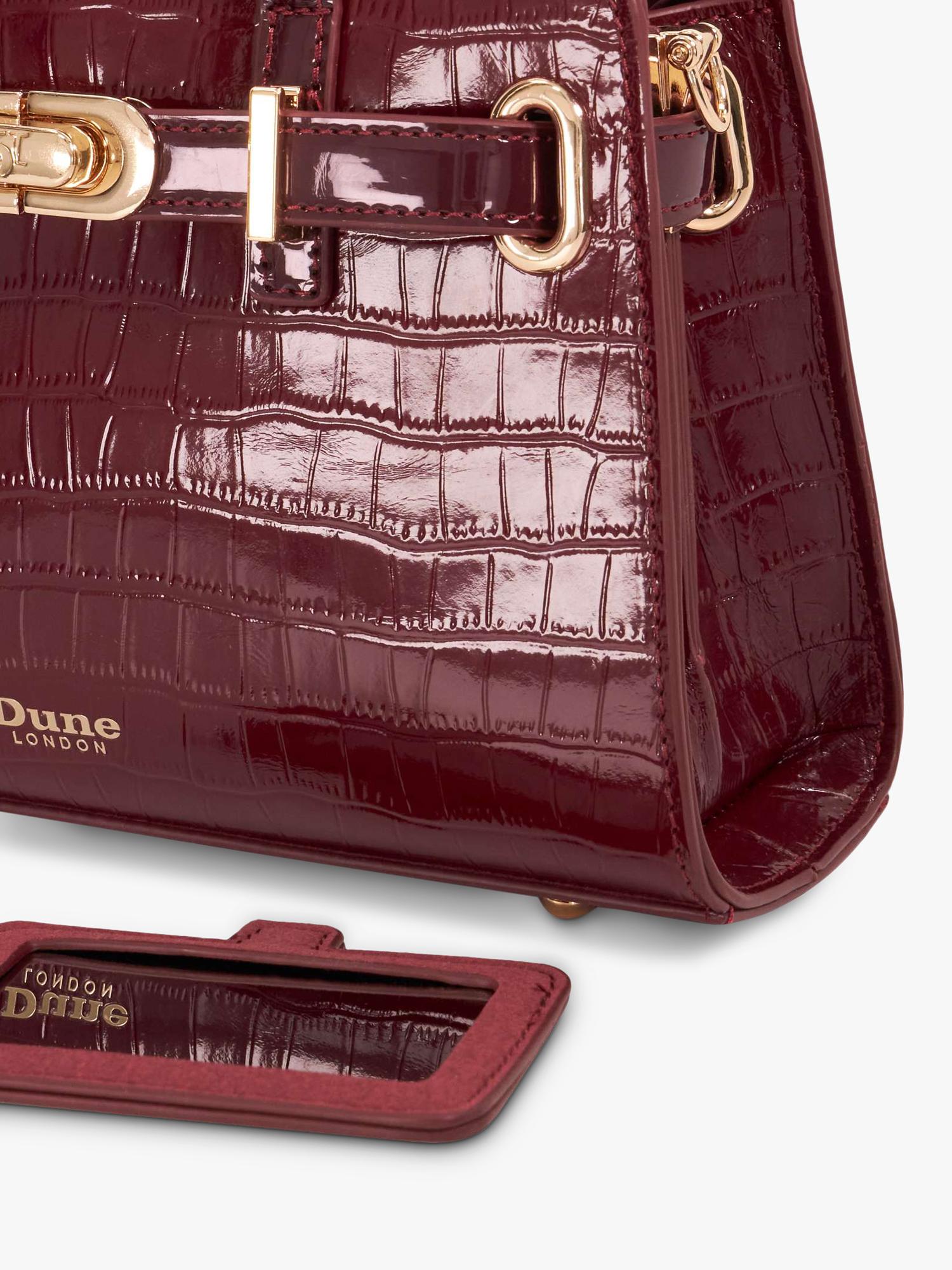 Dune London burgundy leather grab bag with belted detail, imported from the UK
