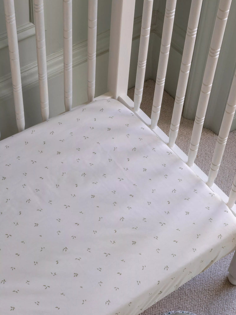 Avery Row cotbed fitted sheet nettle scatter pattern imported from the UK