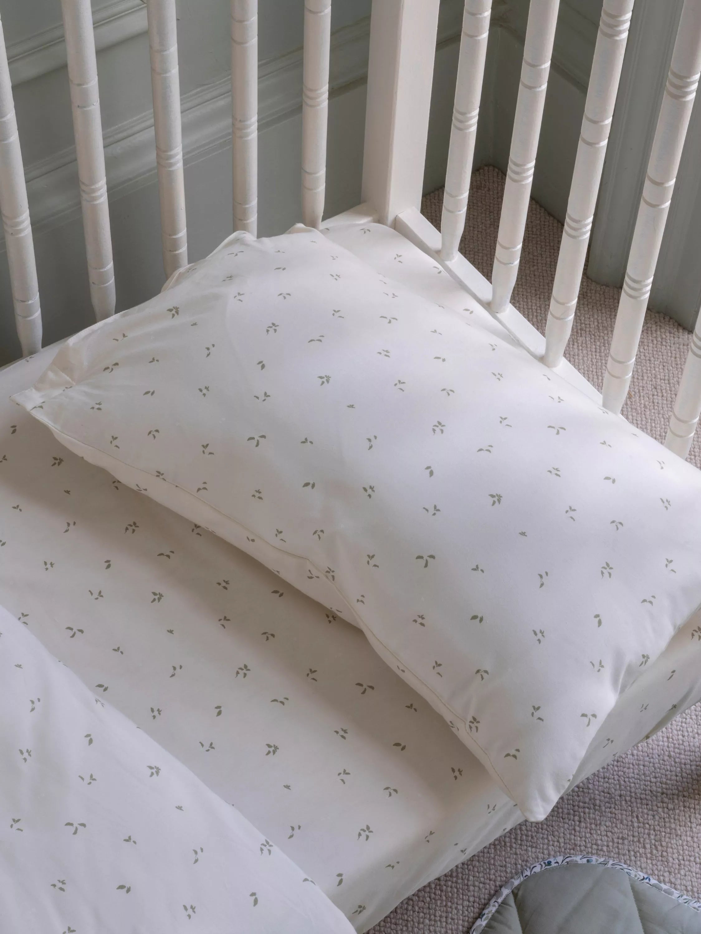 Avery Row cotbed fitted sheet nettle scatter pattern imported from the UK