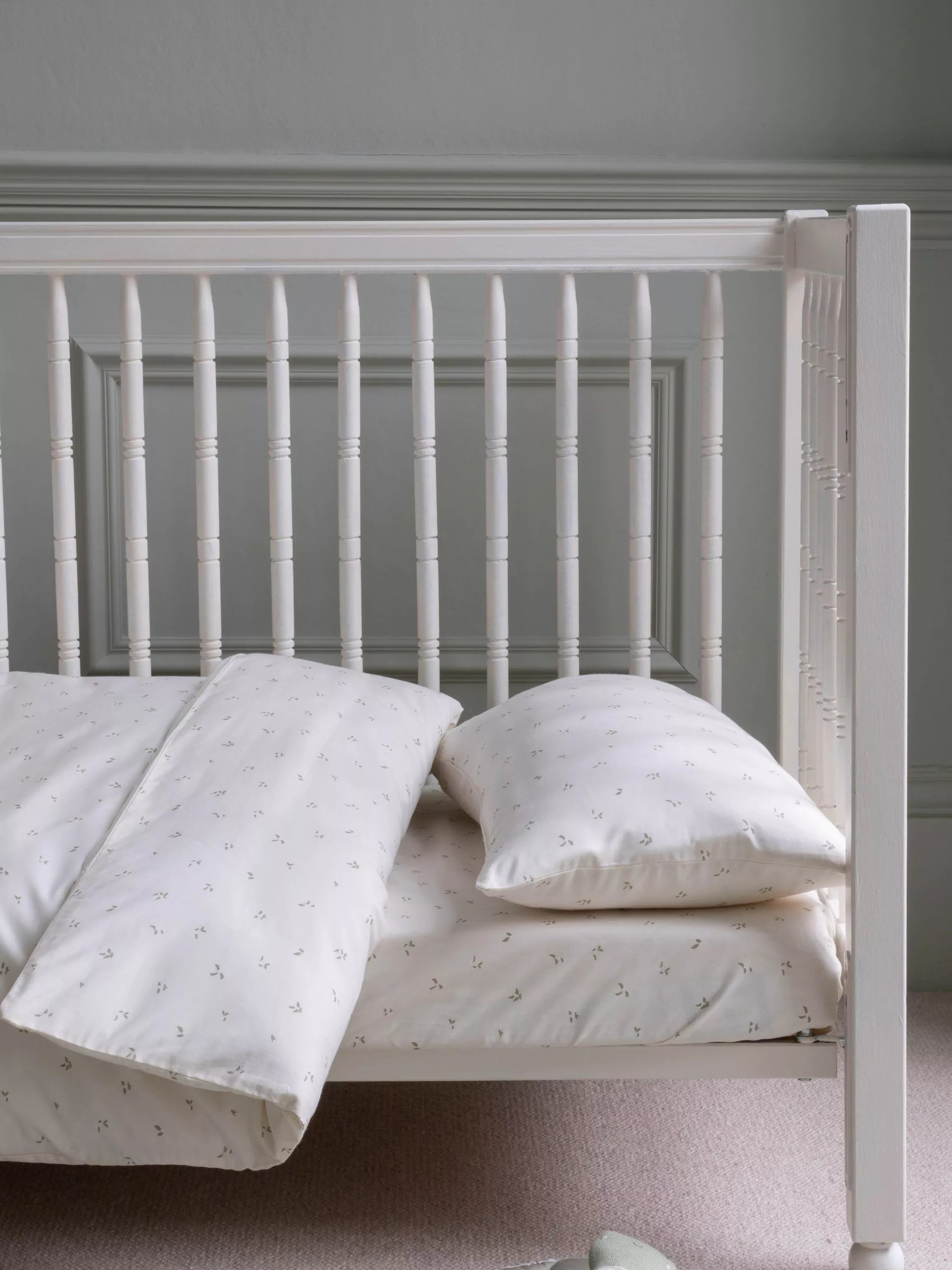 Avery Row cotbed fitted sheet nettle scatter pattern imported from the UK