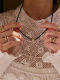Daisy London crystal bead necklace on black cord gold, imported from the UK