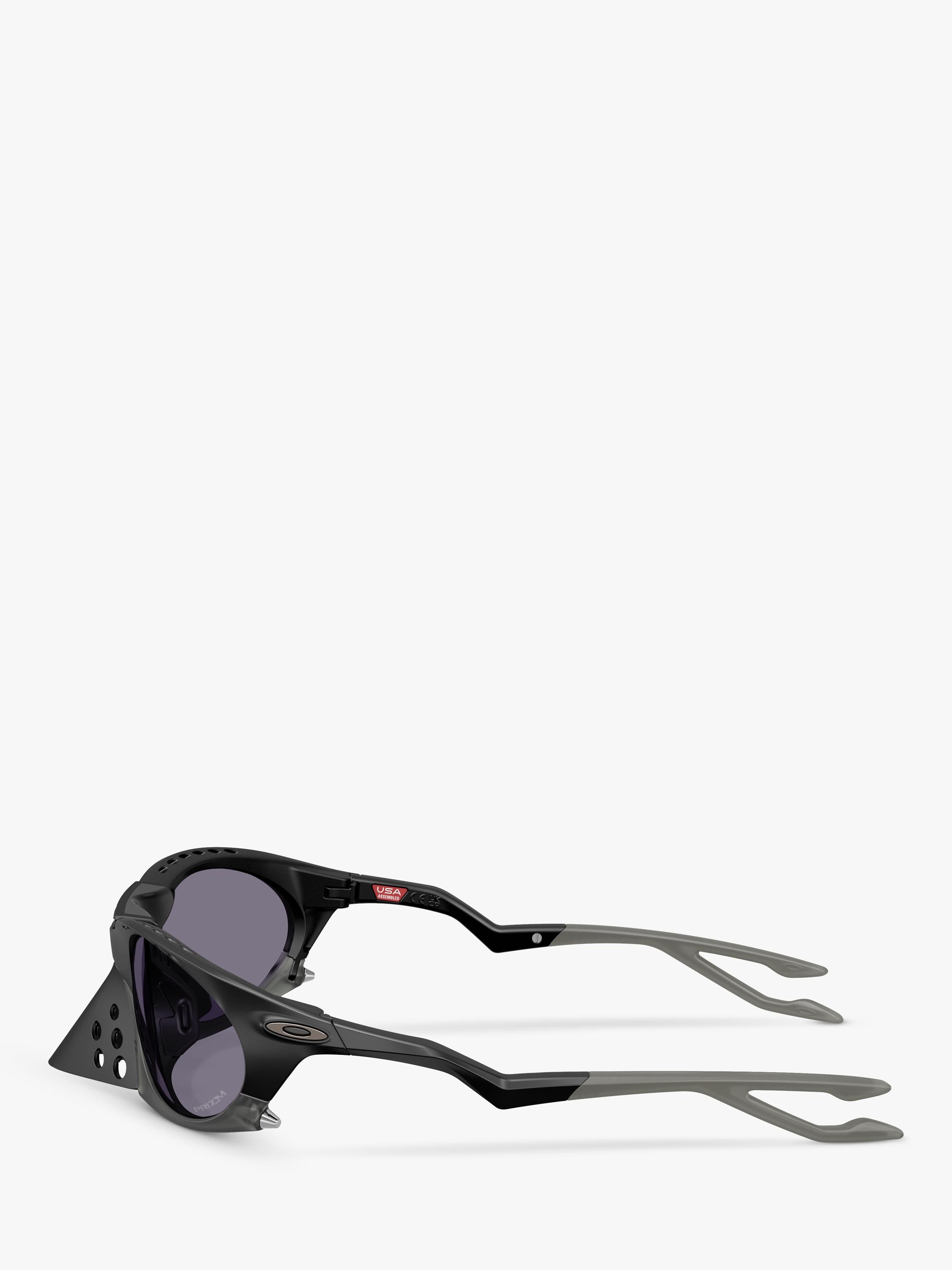 Oakley OO9437 tinted oval sunglasses, imported from the UK
