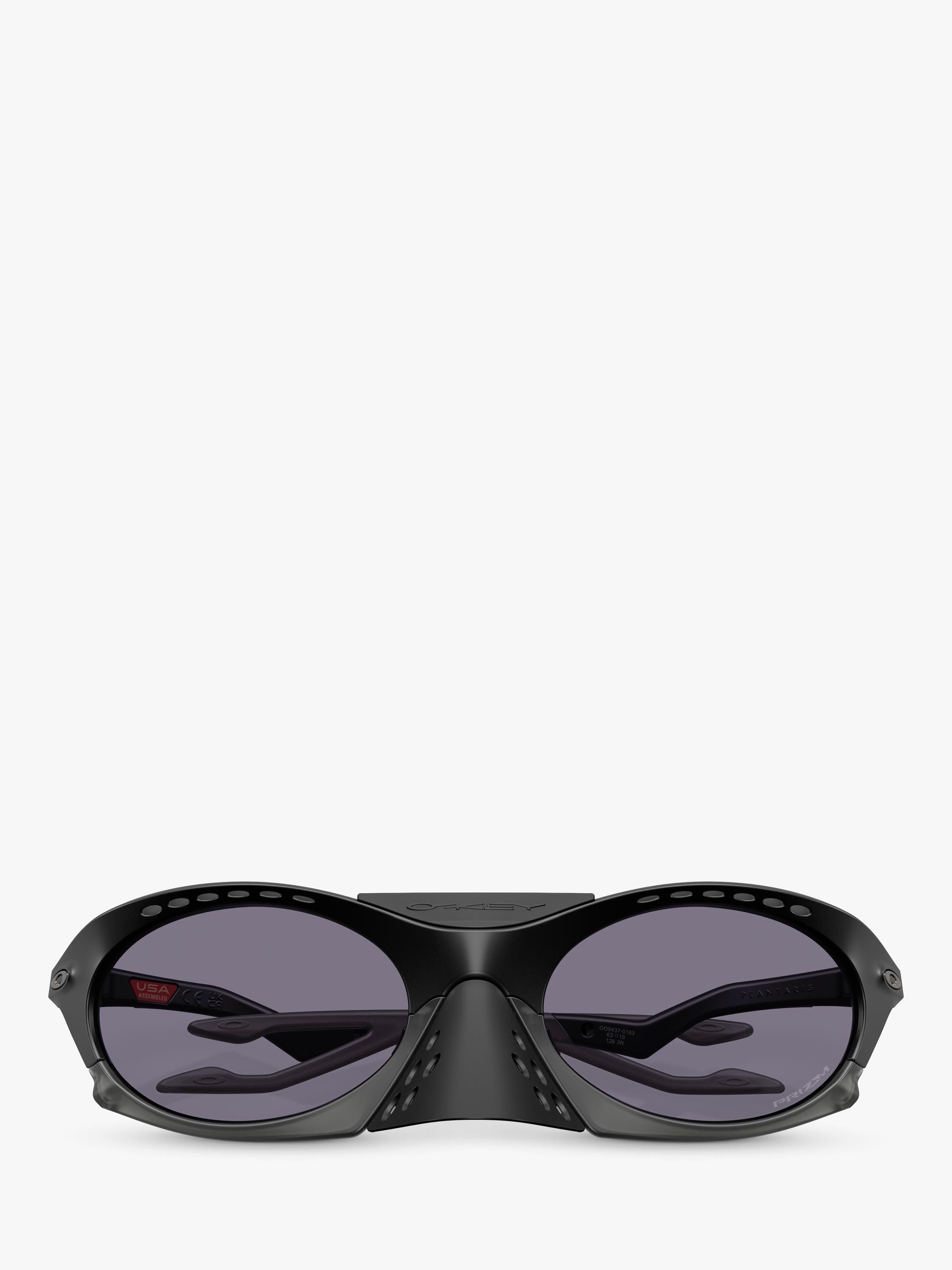Oakley OO9437 tinted oval sunglasses, imported from the UK