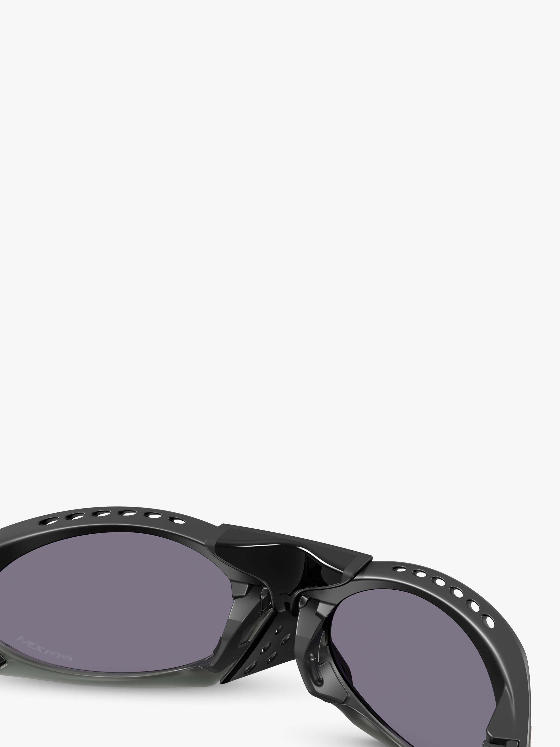 Oakley OO9437 tinted oval sunglasses, imported from the UK