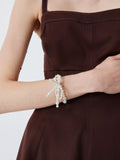Completedworks glass pearl bow bracelet gold, UK version