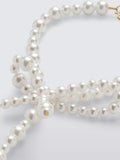 Completedworks glass pearl bow bracelet gold, UK version