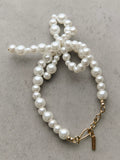 Completedworks glass pearl bow bracelet gold, UK version