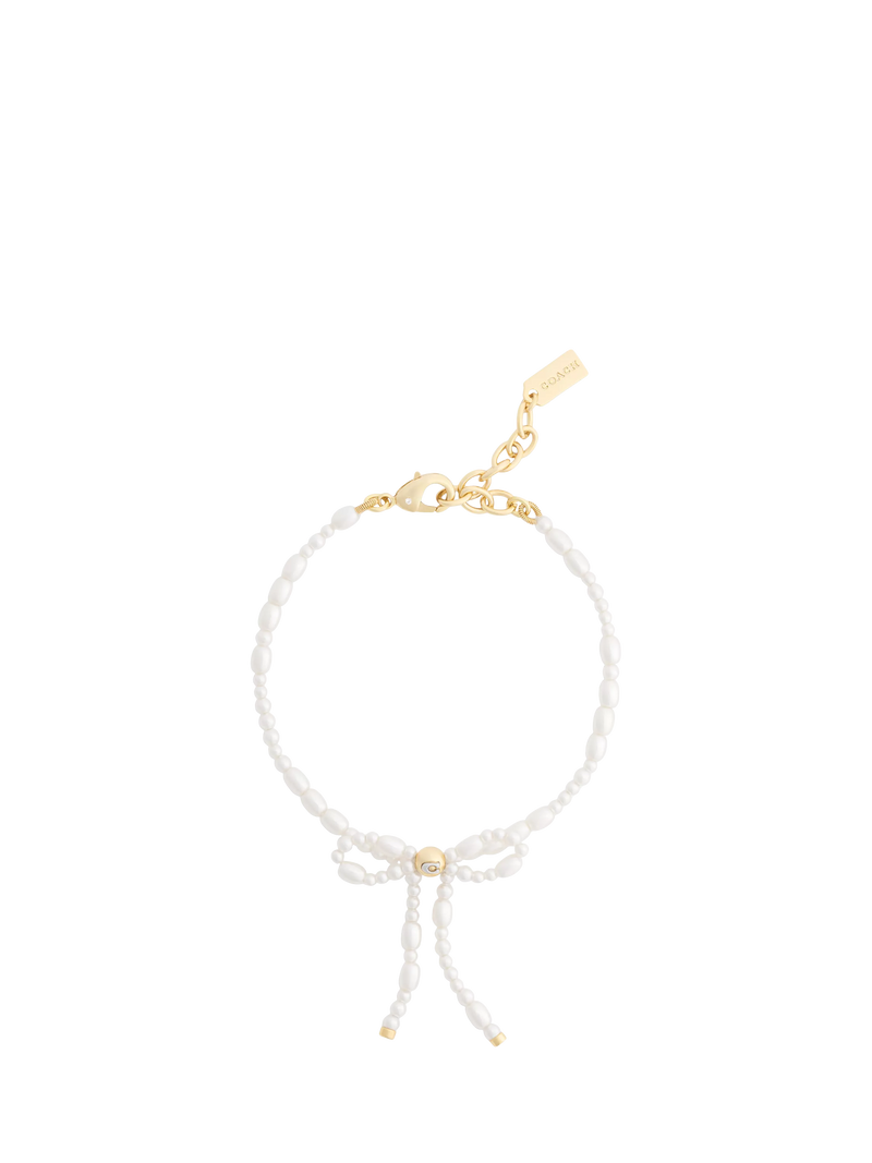Coach pearl bow bracelet with gold tone accents, UK version
