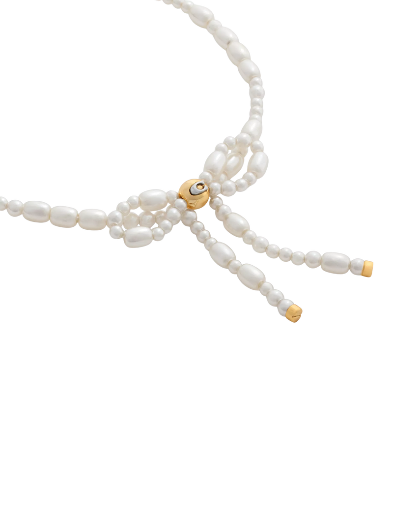 Coach pearl bow bracelet with gold tone accents, UK version