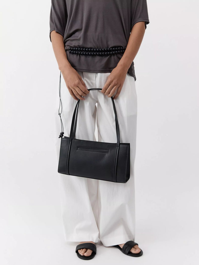 St. Agni minimal black leather pocket bag, UK version