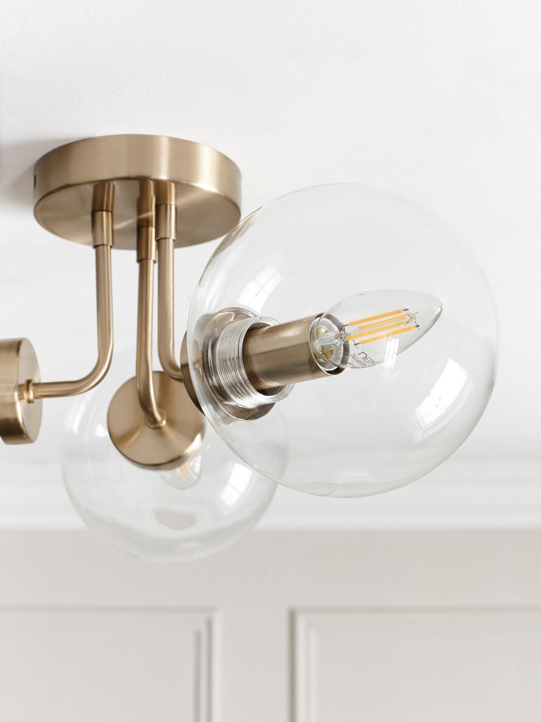 Brass Jackson flush ceiling light with three clear glass shades, UK version
