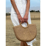 Round woven straw holdall with circular handle (British brand)