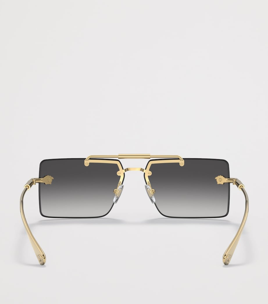 Lunettes de soleil rectangulaires sans monture Versace en métal doré - Produit britannique