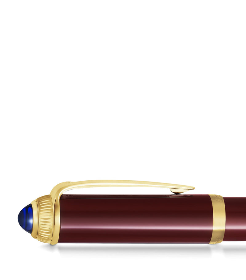 Cartier composite rollerball pen with gold-tone details and blue resin cabochon, 15cm length - British product