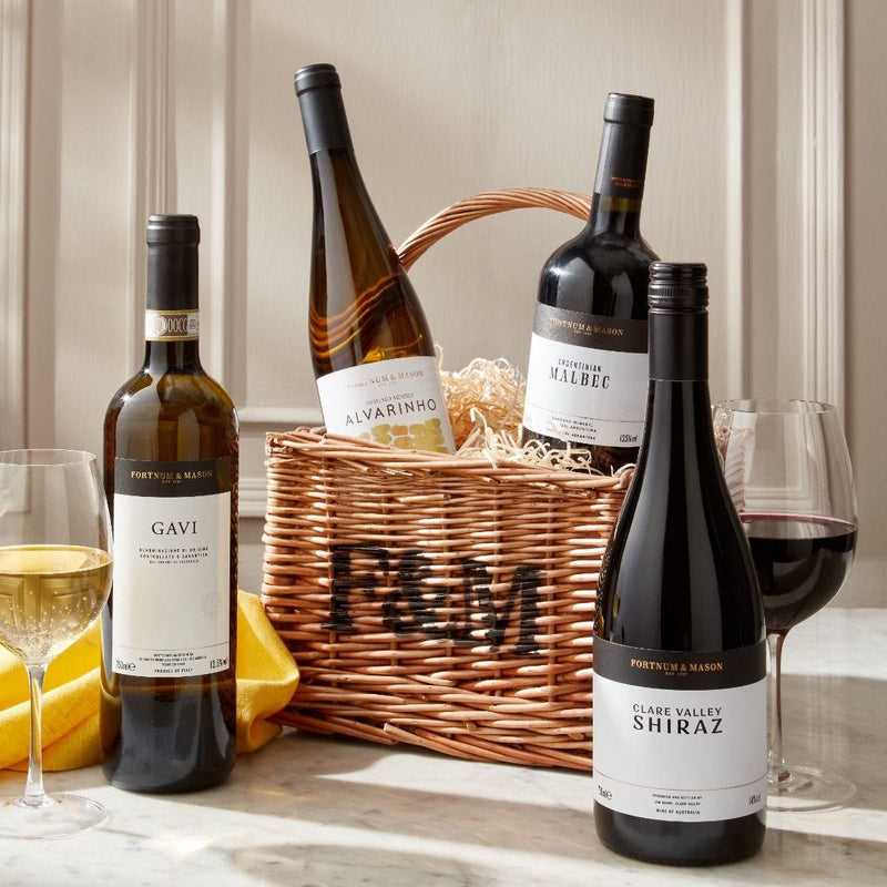 Wicker wine hamper with four assorted bottles, imported from the UK