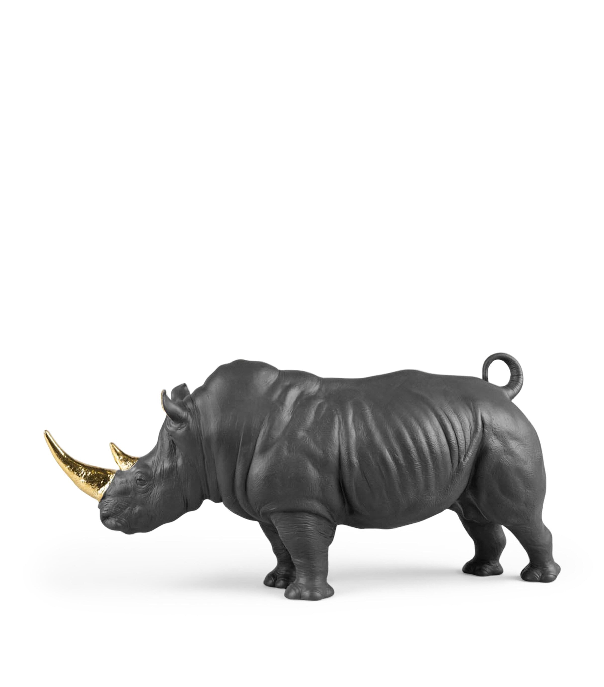 Lladró porcelain rhino figurine with gold accents, 22cm high, UK version