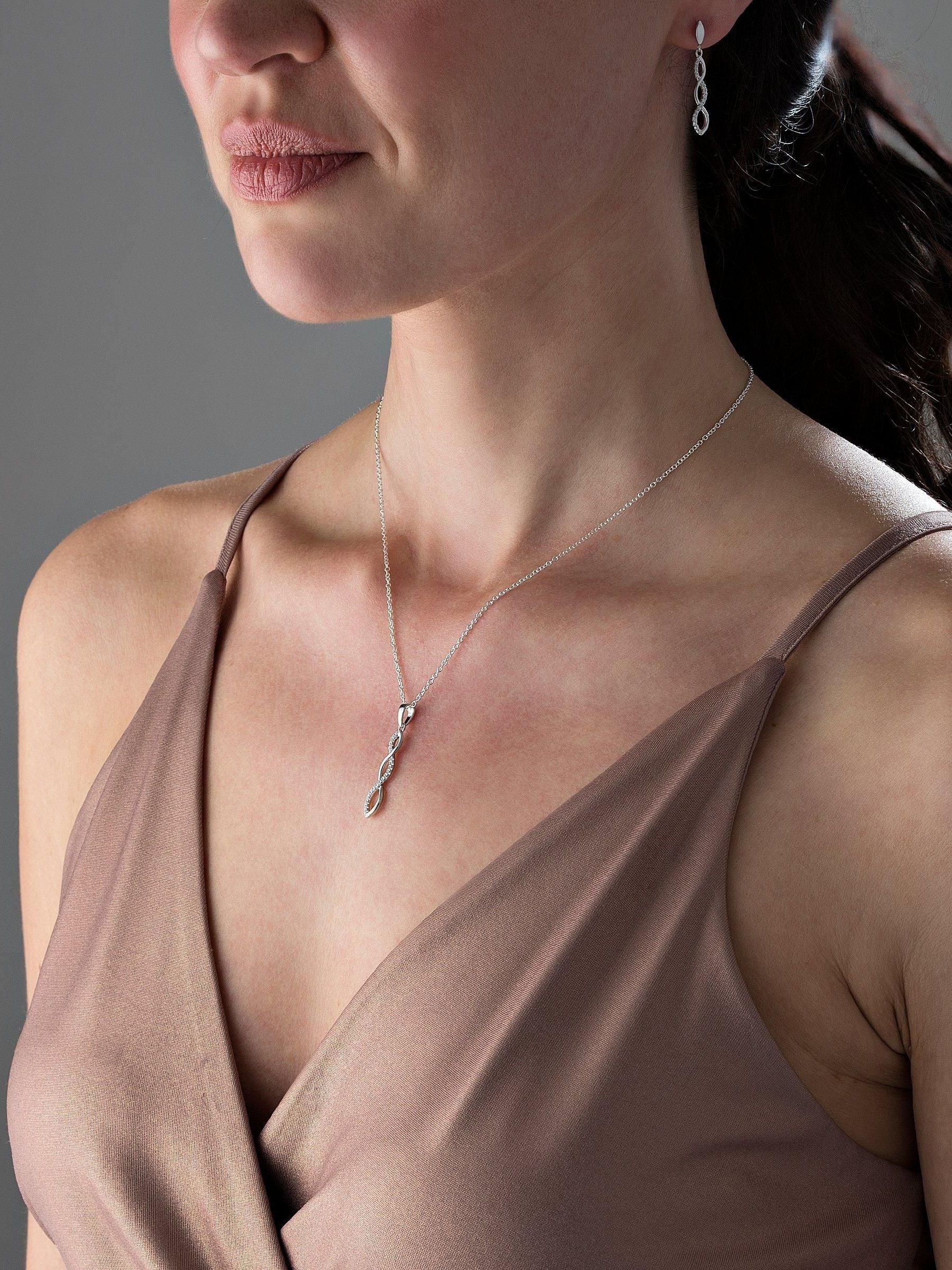 Infinity cubic zirconia pendant and earrings set in sterling silver (British brand)