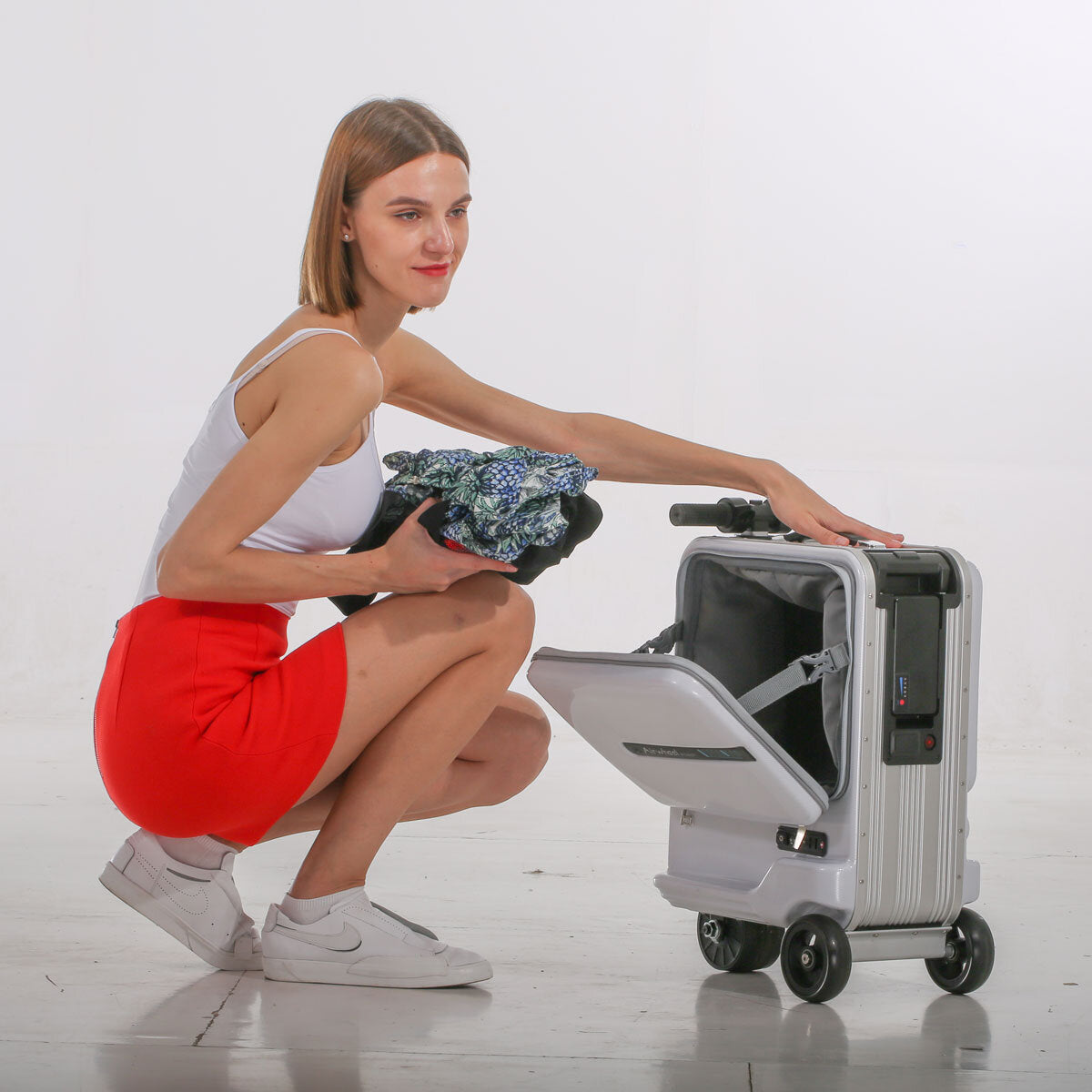 Airwheel electric ride-on suitcase in black or silver, imported from the UK