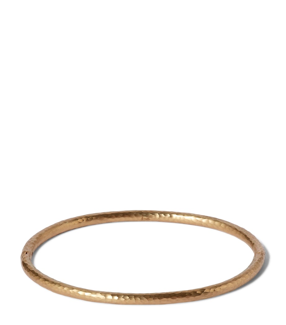 Annoushka yellow gold bangle with hand-hammered finish, imported from the UK