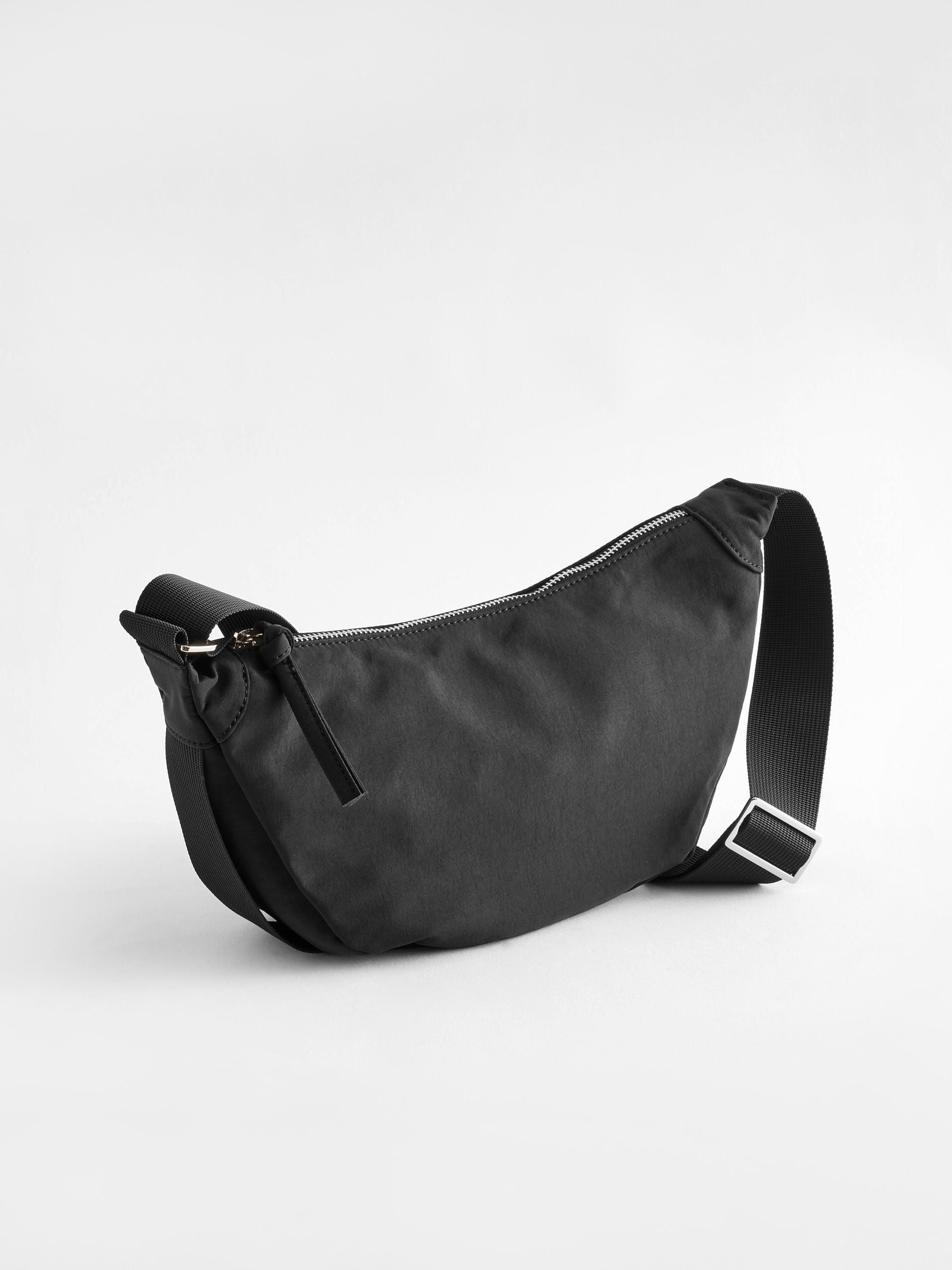 Black sling bag 30cm wide with recycled lining (British brand)