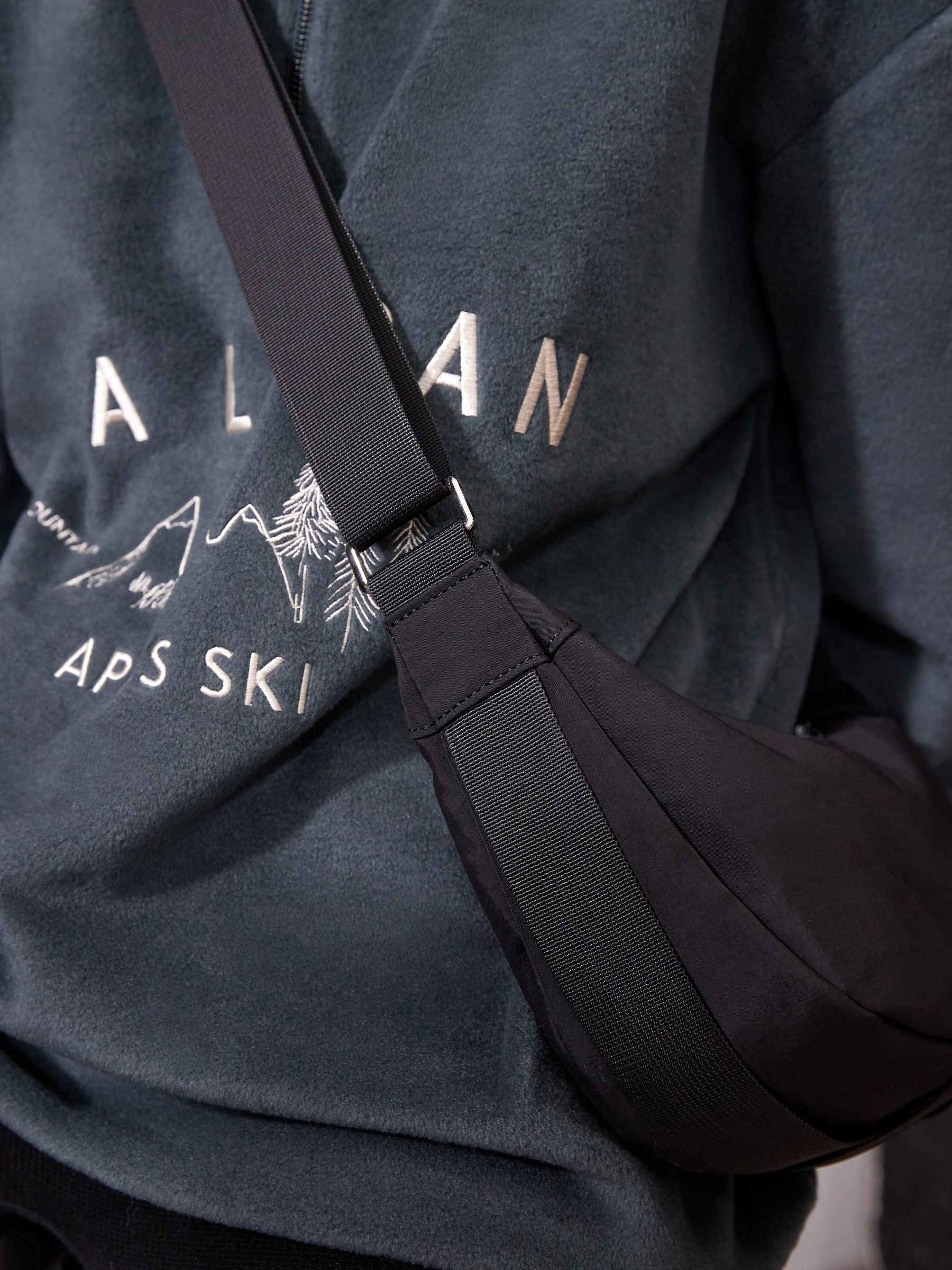 Black sling bag 30cm wide with recycled lining (British brand)