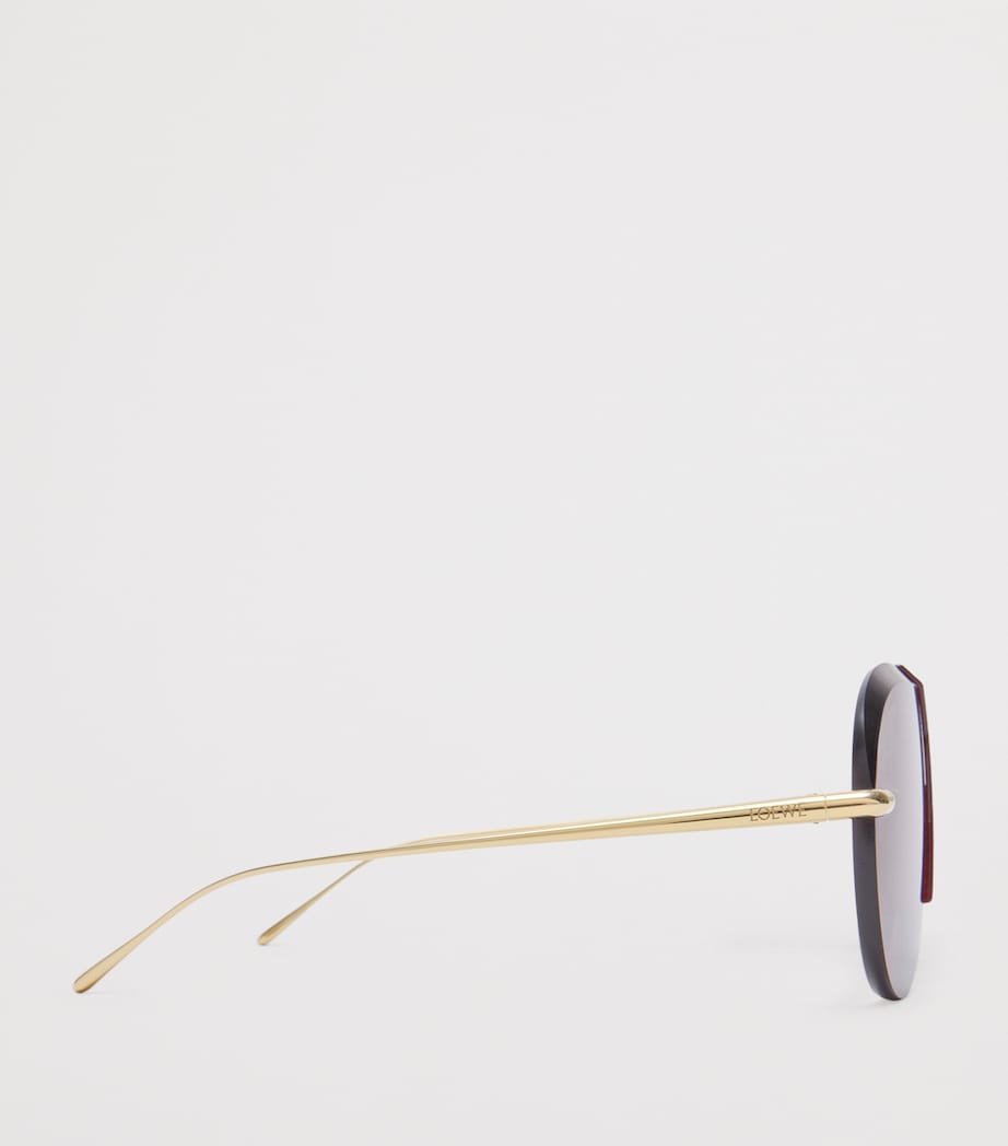 LOEWE aviator sunglasses with red tint and steel frame, imported from the UK