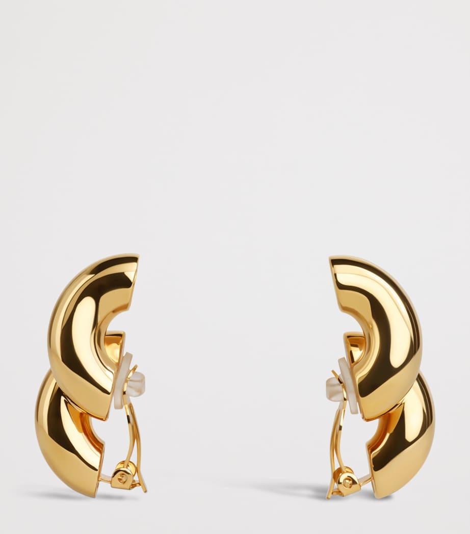 Alaïa Torsion drop earrings brass, imported from the UK
