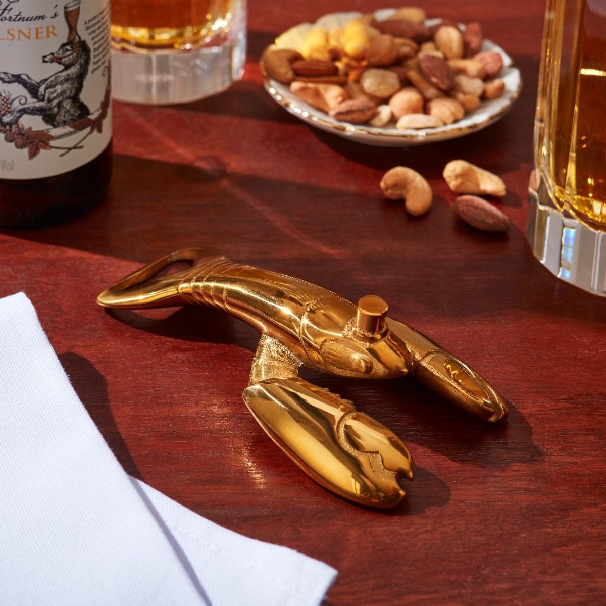 Fortnum's lobster bottle opener in metallic gold with engraved logo - British product