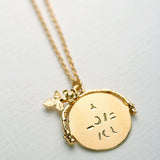 Alex Monroe gold spinning necklace with hidden message, imported from the UK