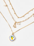 Oliver Bonas faux pearl lemon pendant necklace, imported from the UK