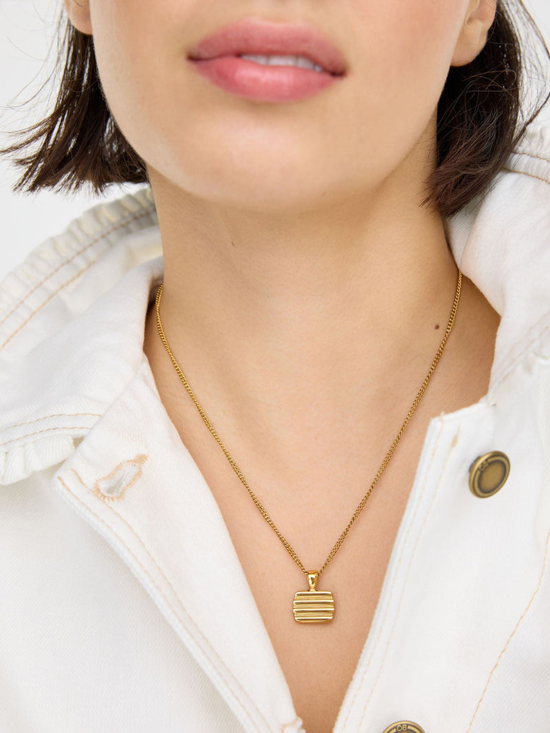 Oliver Bonas gold tone waterproof ridged disc pendant necklace, UK version