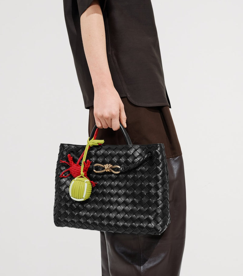 Bottega Veneta green leather tennis ball charm, imported from the UK