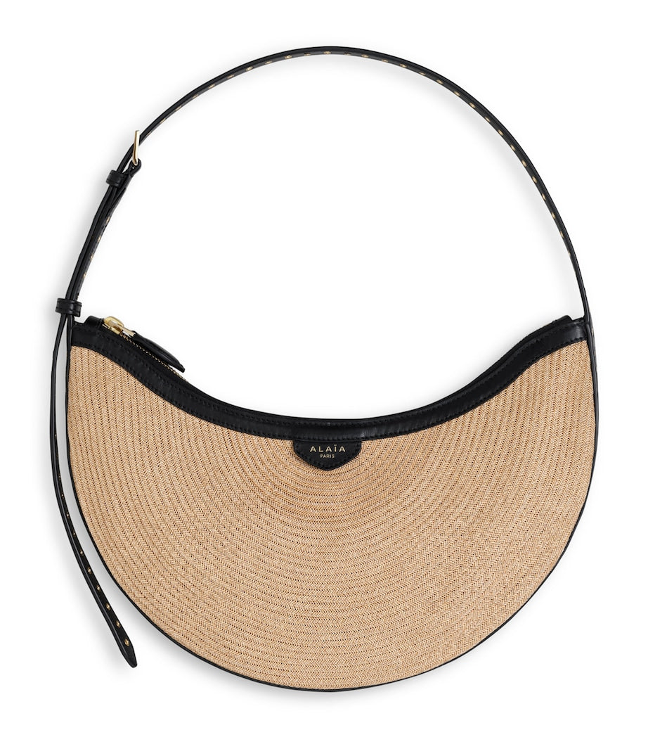 Alaïa Demi Lune woven straw shoulder bag - British product