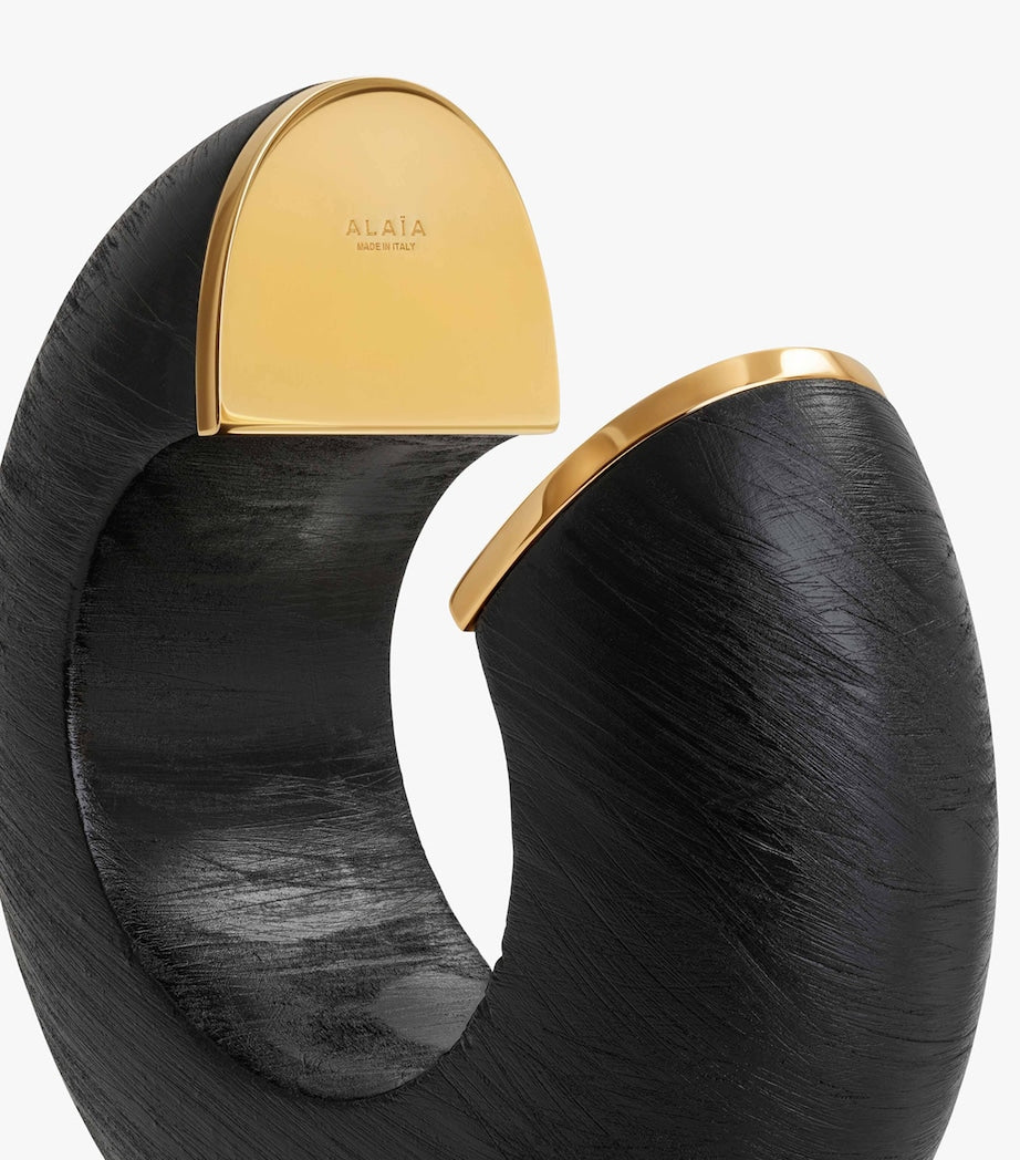 Alaïa wood and brass bumper cuff, imported from the UK