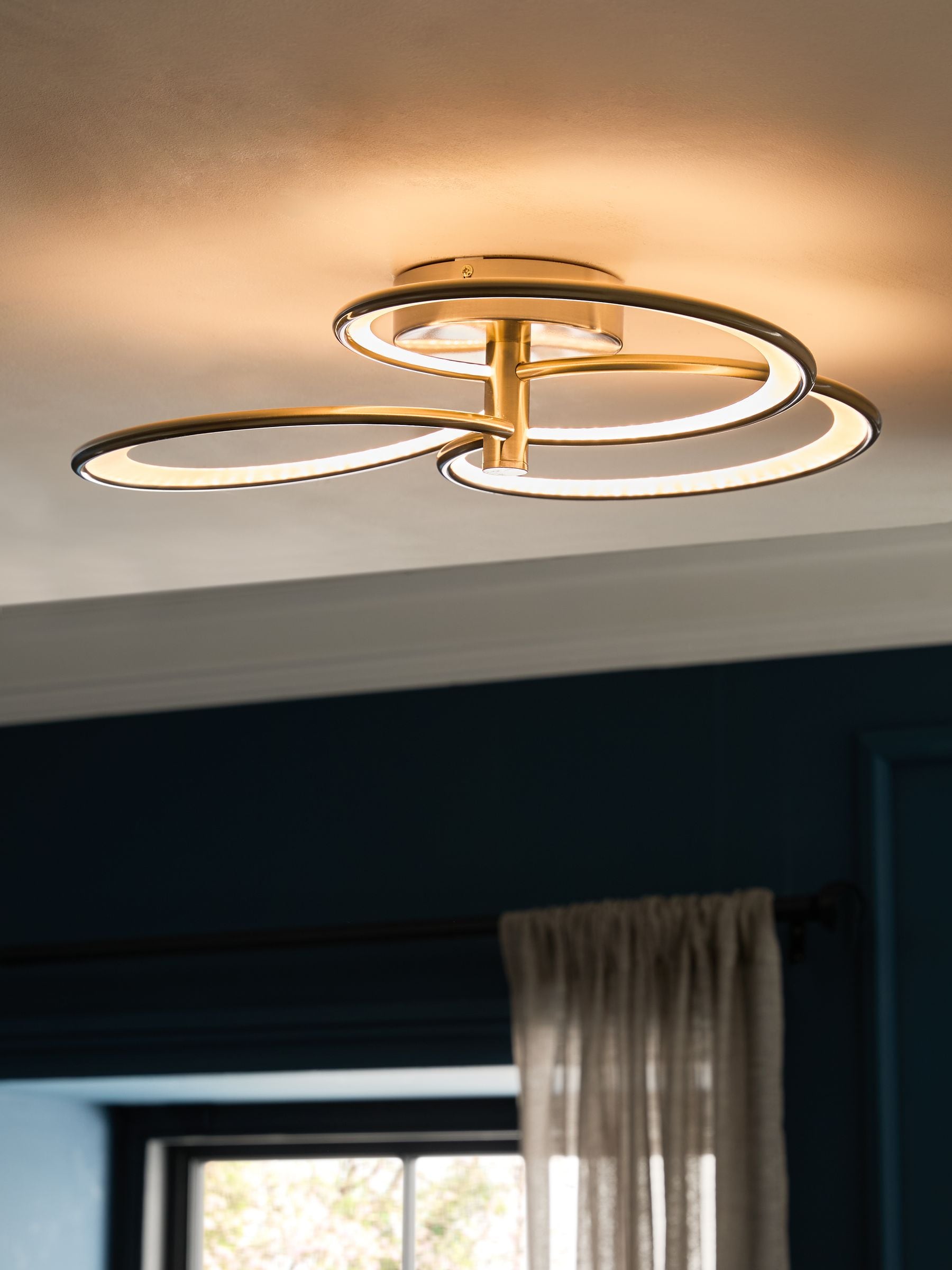 Raya flush ceiling light with brass finish and integrated LED (British brand)