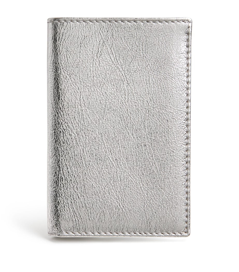 Comme des Garçons vertical bifold card holder with gold accents, imported from the UK