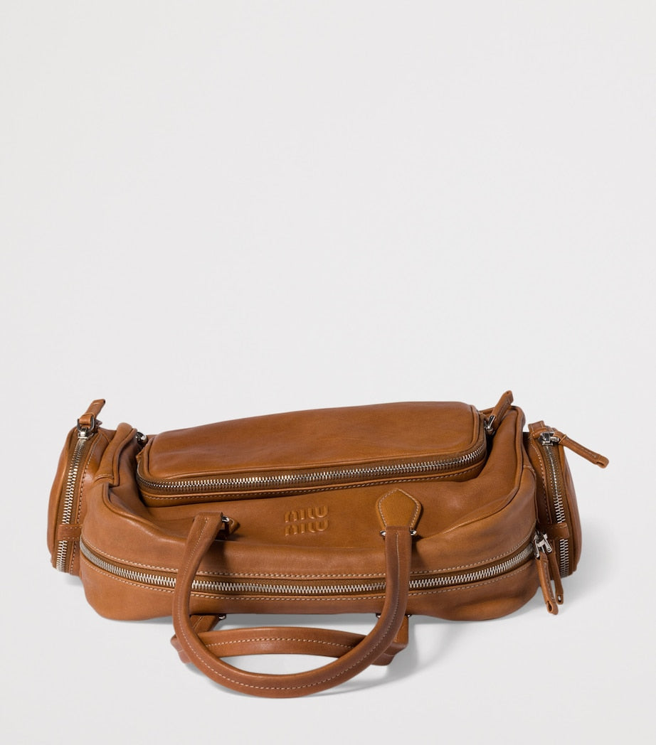 Miu Miu nappa leather top-handle bag with utility pockets (British brand)
