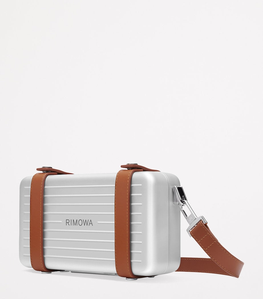 RIMOWA aluminium cross-body bag with leather strap (British brand)