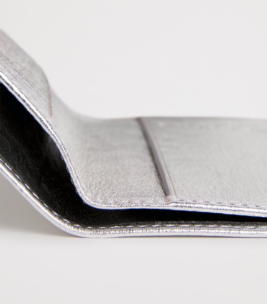 Comme des Garçons vertical bifold card holder with gold accents, imported from the UK