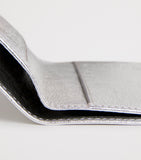 Comme des Garçons vertical bifold card holder with gold accents, imported from the UK