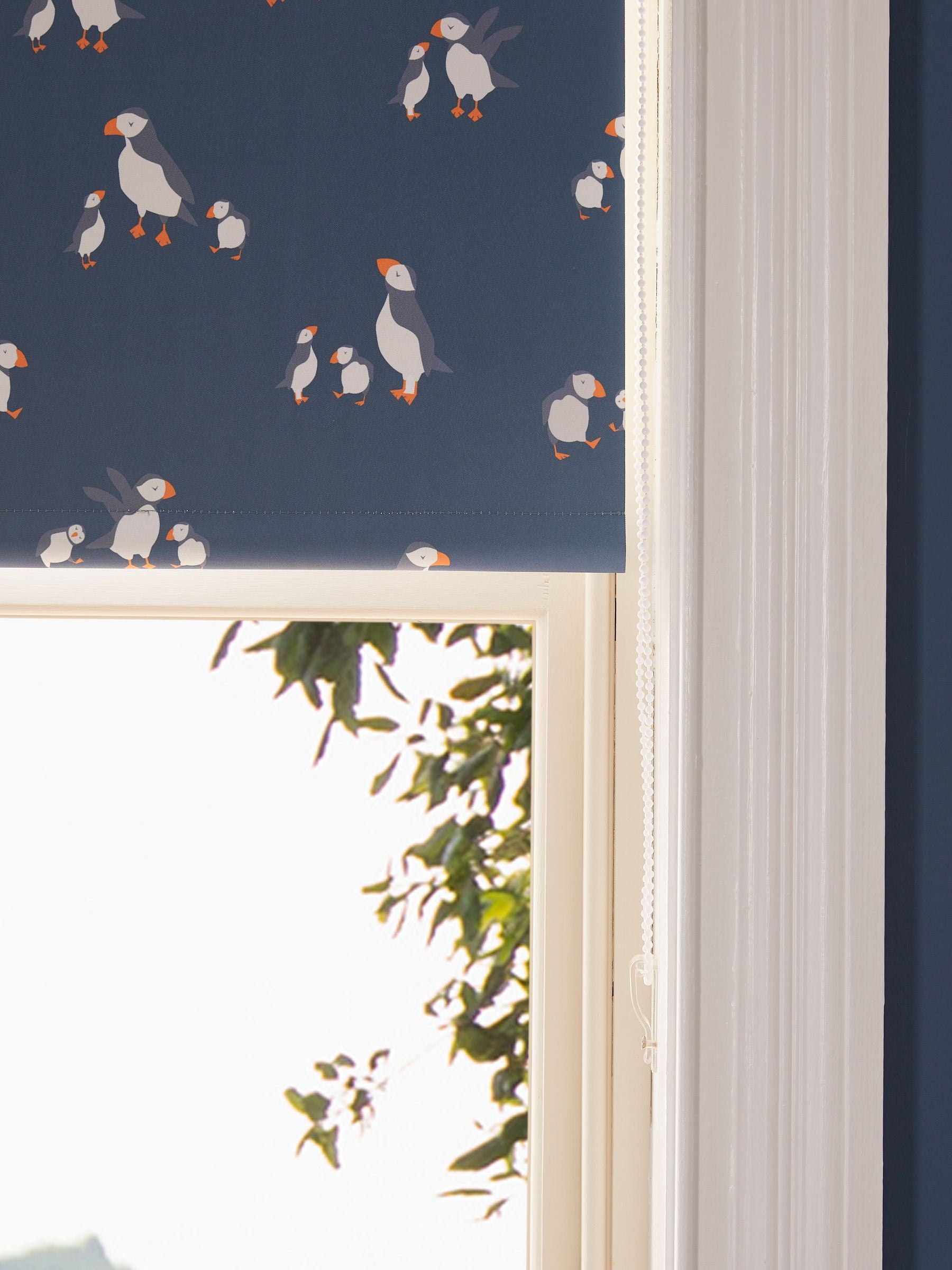 Blue blackout roller blind with puffin print, imported from the UK