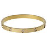 Liars & Lovers gold tone crystal hinged bangle, imported from the UK