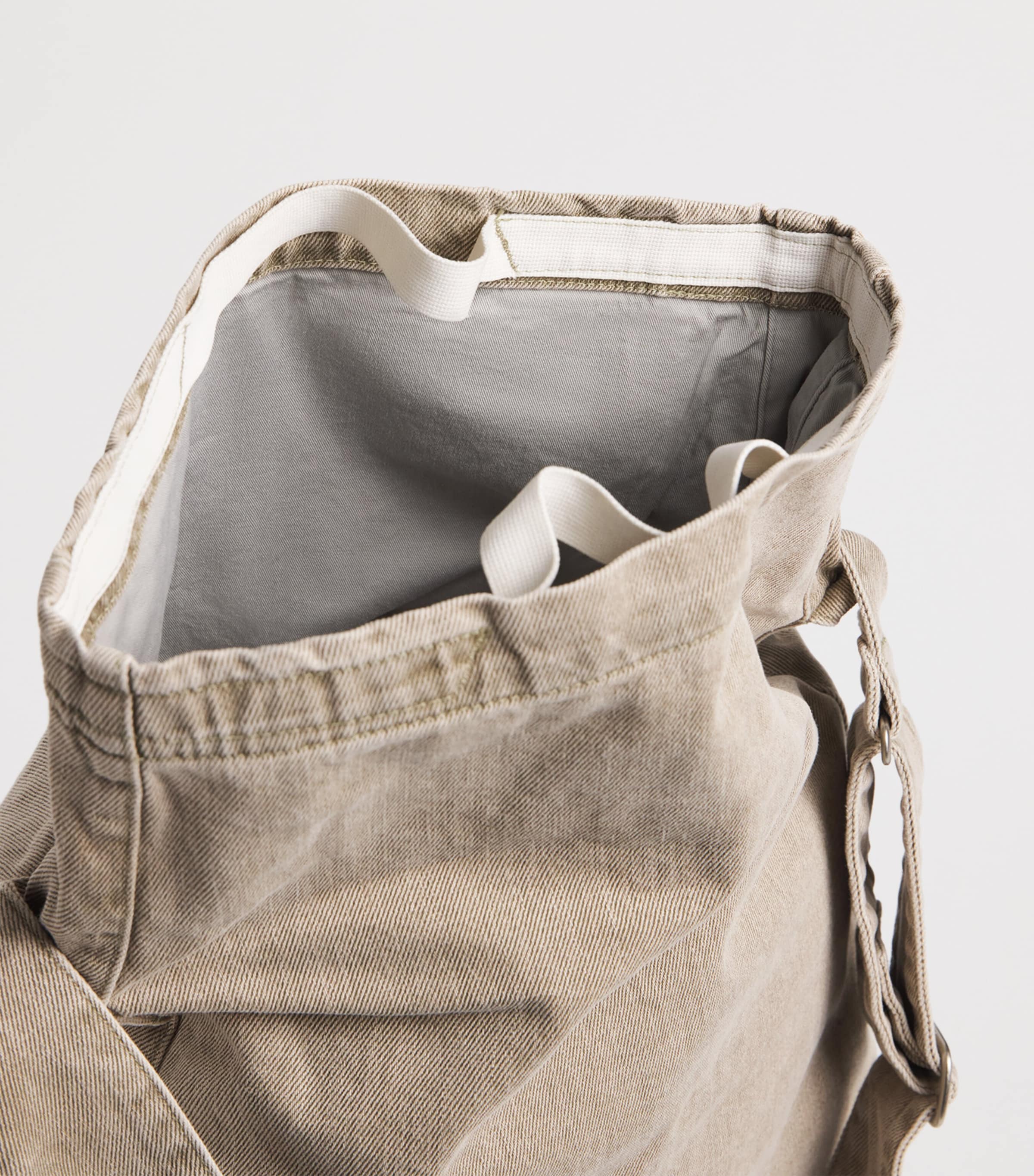 Our Legacy denim sling shoulder bag with mineral pigment, imported from the UK