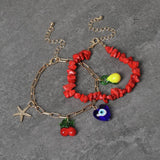 Freedom charm bracelet gold tone with red bead detail 19cm, imported from the UK
